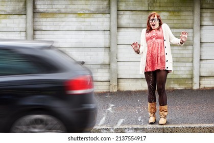 Standing In The Wrong Place. A Young Woman Covered In Water After A Car Drove Past And Splashed Her.