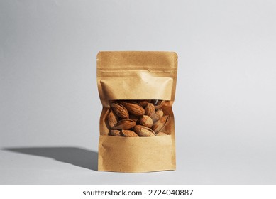 Stand-up pouch with almond nuts on grey background