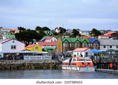 Stanley, Falkland Islands - February, 2020:  A tender boat bringing visitors ashore from a cruise boat is docked at the port.