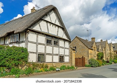 Stanton, Gloucestershire, UK, June 10th, 2021, Narrow lane with romantic thatched timbered framed houses and stone cottages in this lovely village in the Cotswolds.