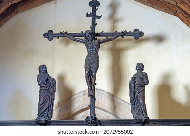 Stanton, Gloucestershire, UK. November 9th, 2021, A close up of the crucifixion of Jesus on the Rood screen designed by Sir Ninian Comper in 1915 in St Michael and All Angels church. 