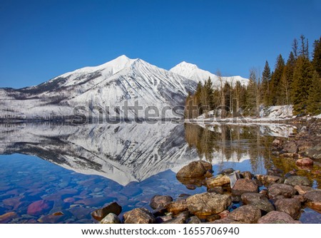 Stanton mountain on Lake McDonald reflection, winter in Glacier National Park, Montana, USA