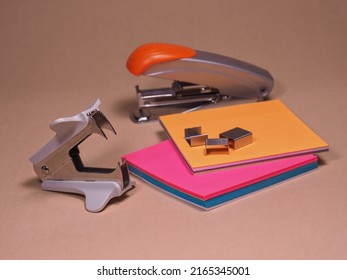 Stapler, staple remover, staples and sticky notes. Office concept. Workplace of a clerk