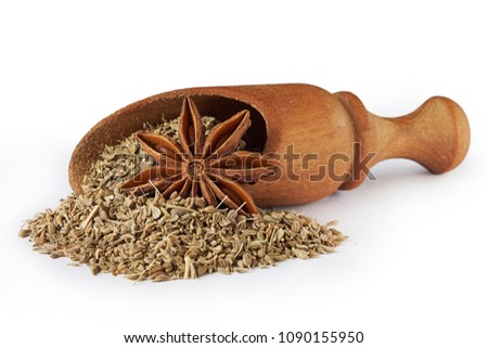 Star anise (Illicium verum) and anise seed, also known as aniseed (Pimpinella anisum) in wooden scoop isolated on white background