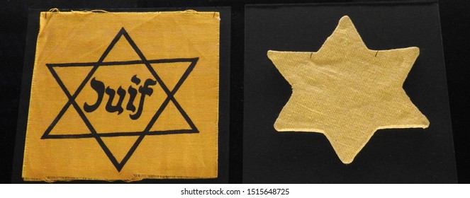 Star Of David Patches Worn By Jews In Territories Occupied By The Third Reich. On The Left Side A Yellow Star With The Word Juif (Jew) In French And On The Right Side Is A Yellow Star Worn In Hungary