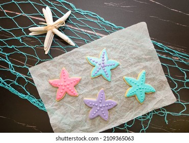 Star Fish Sugar Cookies With Royal Icing On Ocean Theme Background.