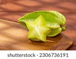 Star fruit or Carambola Green - Averrhoa Carambola; Photo On Wooden Background