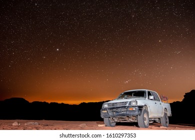 Star Gazing At Wadi Rum Desert In Jordan. Dozens Of Beduin Camps Offer Truck Tours And Tourist Accommodation In The Desert Under Clear Night Skies.