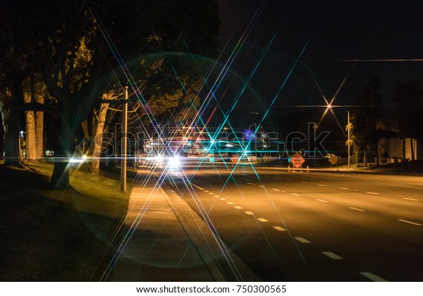 star lens flare on the\
road at night