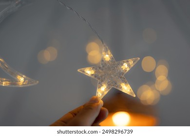 Star light, LED decoration, Hand holding star light, Fairy lights, Bokeh effect, - Powered by Shutterstock