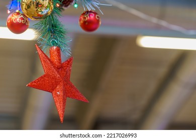 The Star On Top Of The Christmas Tree Is Upside Down. Christmas Decor For The Interior On A Store Shelf. Winter Symbol, New Years Atmosphere. Background With Copy Space For Text