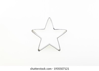 star outline made of shiny metal on white background