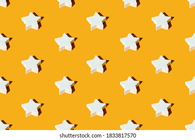 Star pattern. Orange seamless background. Festive design. Quality symbol. Minimalist abstract symmetrical arrangement of white figures ornament isolated on bright yellow.
