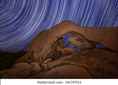 Star Trail Streaks Over The Rocks Of Joshua Tree Park