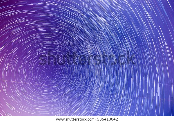 Star trails around Polaris/ Pole\
star with meteors and aeroplanes during perseid meteor shower.\
Concept:Shooting stars, Timelapse, Astronomy,\
Astrophysics