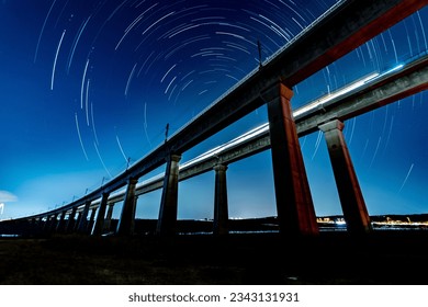 Star trails background om twin train bridges - Powered by Shutterstock