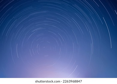 star trails in blue starry night sky - Powered by Shutterstock