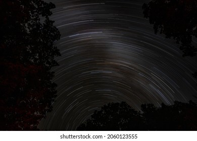 Star trails over forest at night in Canada - Shutterstock ID 2060123555