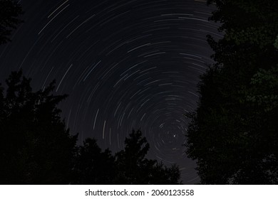 Star trails over forest at night in Canada - Shutterstock ID 2060123558