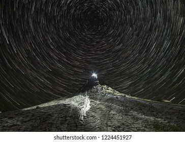 Star trails over the muddy volcano landscape in Romania