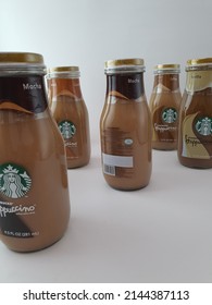 Starbucks Frappucino Chilled Coffee Drink. Random Glass Bottles Arrangement With White Background. Halal Logo On The Back Of The Bottle. Caramel, Mocha And Vanilla Flavor. Malaysia. April 2022