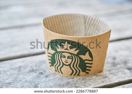 Starbucks logo paper on a wooden table
