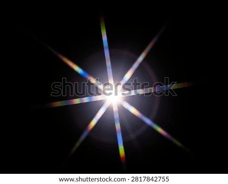 a starburst effect with distinct rainbow-colored diffraction streaks, which occurs when white light from a single point source passes through a specialized optical pattern or structure