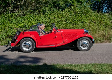 Starcross, Devon, UK. July 9th 2022. MG TD Classic Car In Red. An Open Top Retro Sports Car Driving Down An English Country Road. 