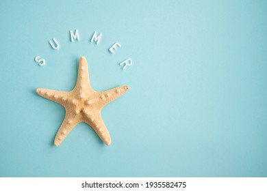 Starfish auf blauem Hintergrund und das Wort Sommer. Urlaubskonzept. 