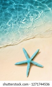 Starfish On The Sand Beach And Ocean As Background. Summer Beach