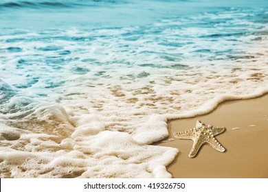 Starfish and soft wave on the sandy beach summer tropical concept - Powered by Shutterstock