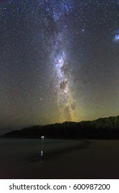 Stargazing Of Southern Sky At Empty Sandy Beach On A Calm Cloudless Night Seeing Milky Way And Southern Cross Constellation.