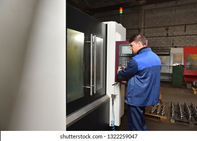 Stariy Oskol Russia - 18.01.2018: A young worker is watching how a part is being machined in the CNC machine. - Shutterstock ID 1322259047