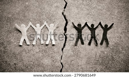 A stark image showing two groups of paper figures, one white and one black, separated by a deep crack in a rough concrete surface, symbolizing division and conflict.