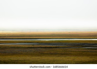 Stark Landscape In Iceland With Electricity Poles