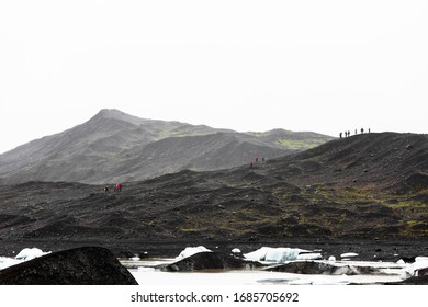 Stark Landscape With People And Icebergs