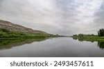 A stark view of the Red Deer River in Alberta, while crossing on the Bleriot Ferry on the Dinosaur Trail through the badlands.