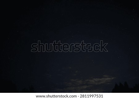 Starlit Night Sky with Subtle Clouds and Silhouetted Trees at Dusk