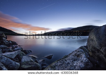 Starry lake landscape at sunset
