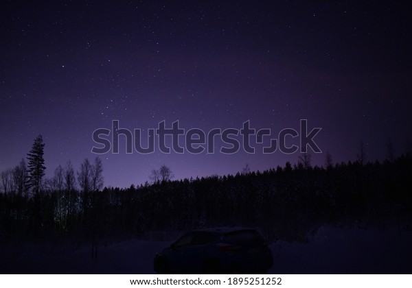 Starry landscape picture\
with a car