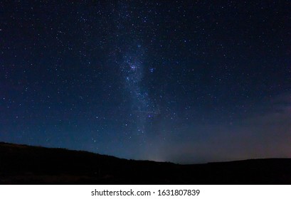 Starry night in full darkness, with lactea pathway lighting up the sky - Powered by Shutterstock