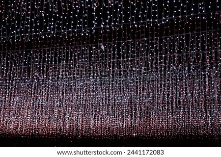 Starry Night Illumination
A mesmerizing display of hanging lights creating a starry night effect, perfect for backgrounds or festive decorations.