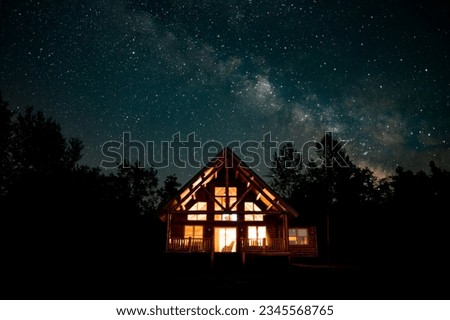 Starry night with Milky Way over a cabin in the woods of northern Michigan