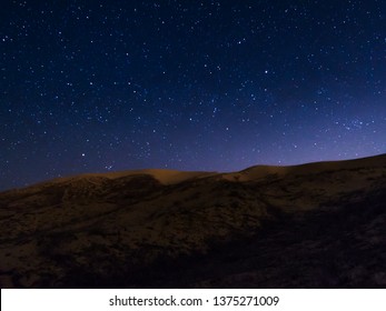 starry night over sand dune - Powered by Shutterstock