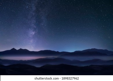 Starry Night Sky With Milky Way Over The Mountains. Soft Focus.