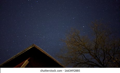 Starry night sky with old barn and tree  - Powered by Shutterstock