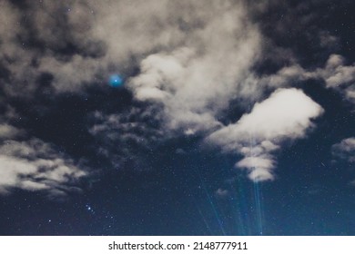 starry night sky with plenty of constellations clearly visible and a few fluffy clouds shot from the Southern Hemisphere in Tasmania, Australia in autumn