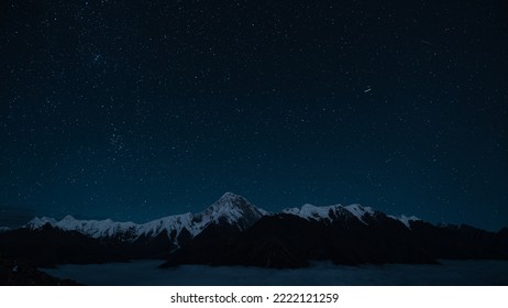 Starry night sky and snow mountain - Powered by Shutterstock