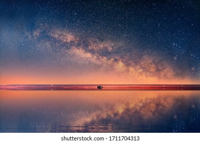 starry night at sunset sea , blue  pink cloudy sky sunset light reflection on water wave reflection on horizon boat skyline nature landscape 
 - Shutterstock ID 1711704313
