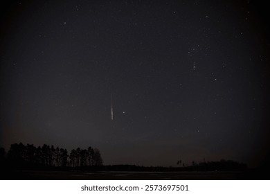 Starry sky with a meteor falling down.